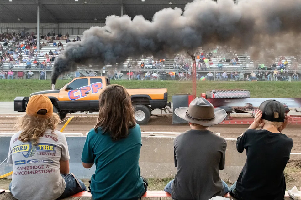 Youngsters sit on a rail to take in the popular truck pull contest during the 2022 Guernsey County Fair. This year's fair will be Sept. 8-14.