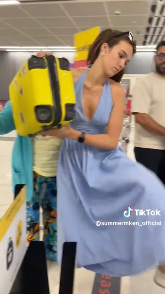 A fierce flyer is going viral for muscling her suitcase into a carry-on sizer at a European airport. TikTok/@summermken_official