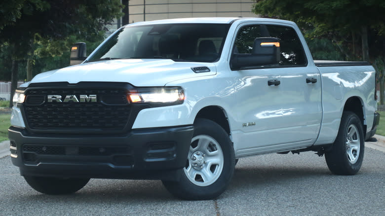 2025 Ram 1500 Tradesman parked on a paved surface with trees and buildings in the background