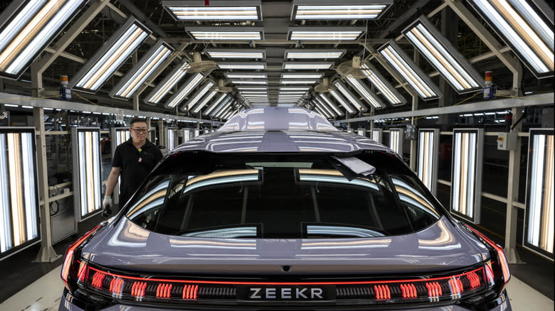 A worker checks the exterior of a finished vehicle on the production line for electric vehicle maker Zeekr at its factory on May 29, 2025 in Ningbo, China. China's automakers account for nearly two-thirds of global sales of electric vehicles and exports more vehicles overseas than any other country. Zeekr, a pure-electric brand aimed at the luxury market, has seen sales growth in the highly competitive Chinese market and is furthering its expansion into Asia, the Middle East, Latin America, and parts of Europe. The company's plans to enter the US market has faced hurdles due to tariffs on China made electric vehicles. In 2024, Zeekr delivered more than 220,000 vehicles, according to the company. Zeekr is among several Chinese EV makers building vehicles in automated factories using robotics powered by artificial intelligence alongside human workers. Zeekr is owned by Geely Holdings, which also has ownership stake in a number of foreign brands including Volvo, Lotus, and Polestar.