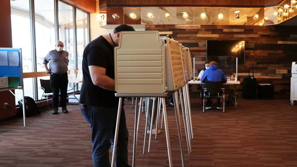 A man fills out his ballot after registering to vote at Vanguard Church in Colorado Springs, Colorado, on November 3, 2020. The church served as a location where voters could register, drop off completed ballots or fill out a ballot in person. (Forrest Czarnecki/The Gazette via AP) - Forrest Czarnecki/The Gazette/AP/File
