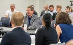  Nebraska Gov. Jim Pillen, center, addresses the new School Financing Review Commission during its first meeting. Aug. 12, 2025. (Zach Wendling/Nebraska Examiner)