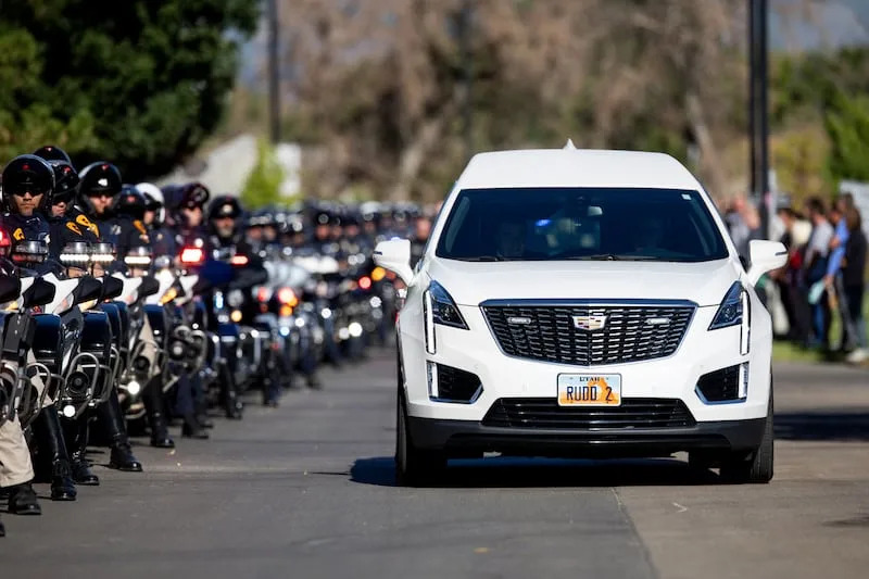 The hearses carrying the bodies of fallen Tremonton-Garland police officers, Sgt. Lee Sorensen and officer Eric Estrada, are escorted by police officers on motorcycles as they depart the Utah State Medical Examiner's Office in Taylorsville to Garland and Logan on Monday. | Rio Giancarlo, Deseret News