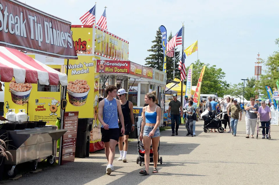 People browse the carnival food vendors at the Emmet-Charlevoix County Fair on Saturday, Aug. 24, 2024.