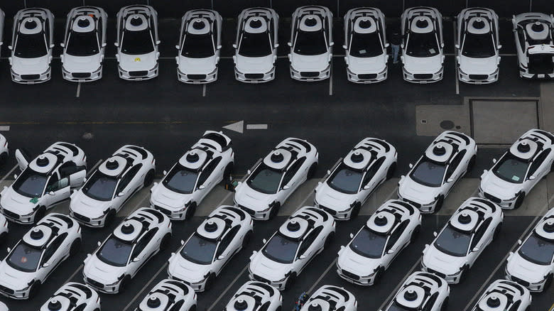 n an aerial view, Waymo cars are seen parked at a Waymo facility on June 10, 2025 in San Francisco, California.