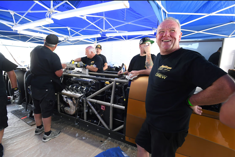race car crew working on a vehicle in a pit area