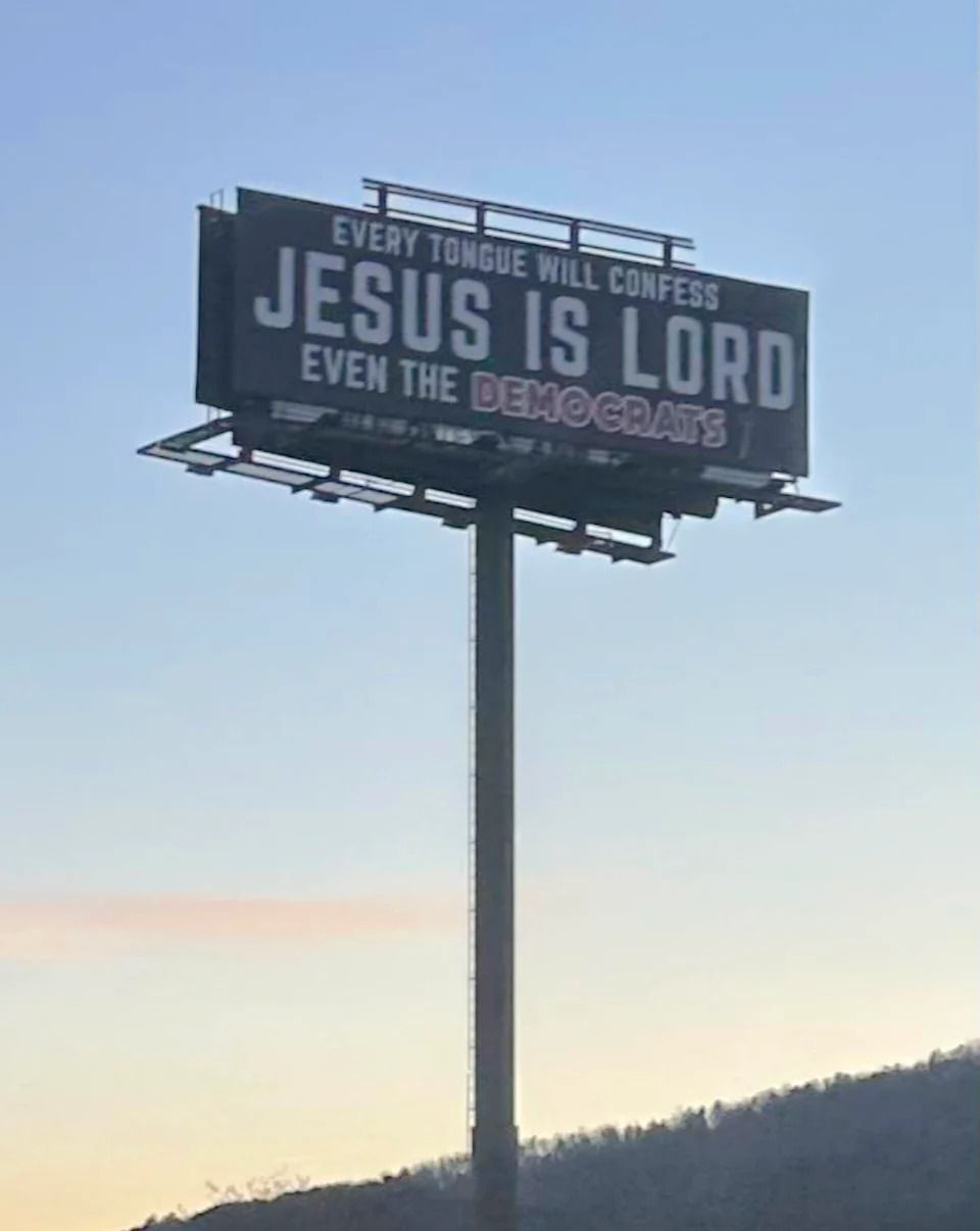 Billboard reads: "Every tongue will confess Jesus is Lord, even the Democrats," against a sky backdrop