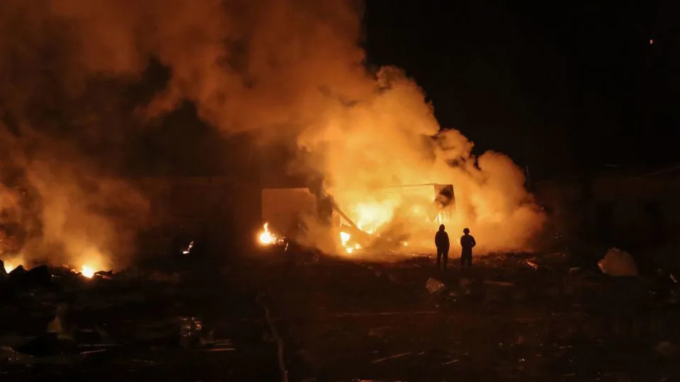 People stand in front of burning building in Okhtyrka, Ukraine, after Russian drone attack on Wednesday. - Andriy Mikheev/Suspilne Ukraine/JSC UA:PBC/Global Images Ukraine/Getty Images