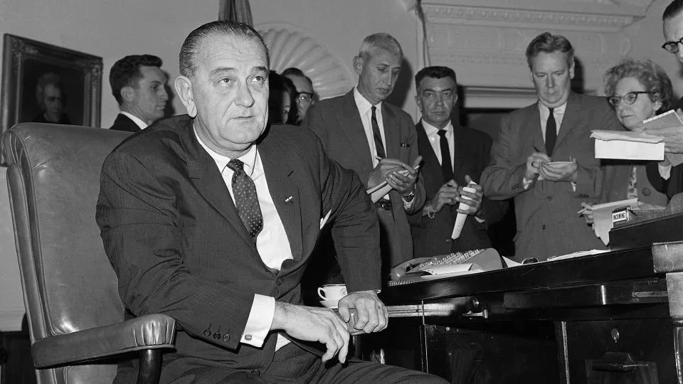 President Lyndon B. Johnson sits at his desk in Washington, DC, before announcing he would federalize the Alabama National Guard to protect civil rights demonstrators in Selma, Alabama, on March 18, 1965. - Bettmann Archive/Getty Images