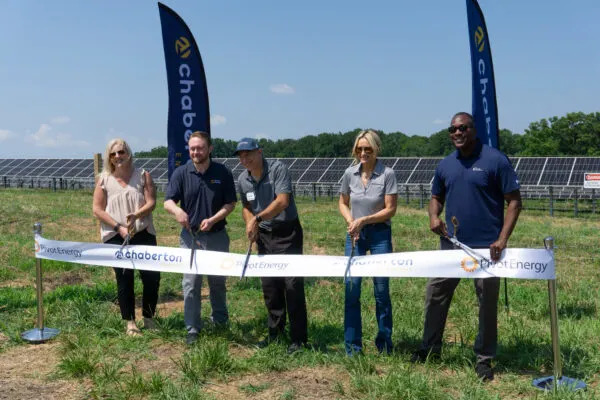 Solar industry officials from Chaberton and Pivot Energy cut the ribbon on the Lime Kiln community solar array with Howard County Executive Calvin Ball, right, on July 8. (Photo by Christine Condon/ Maryland Matters)