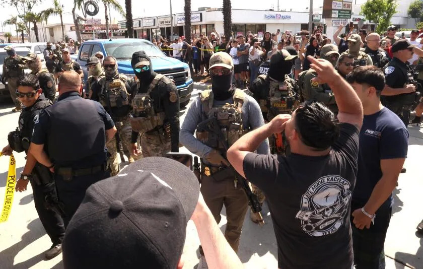 Residents confront ICE and Border Patrol agents over a raid