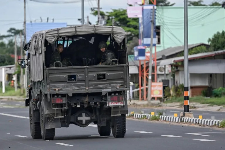 Royal Thai Army soldiers sit in the back of an army vehicle in the Thai border province of Surin (Lillian SUWANRUMPHA)