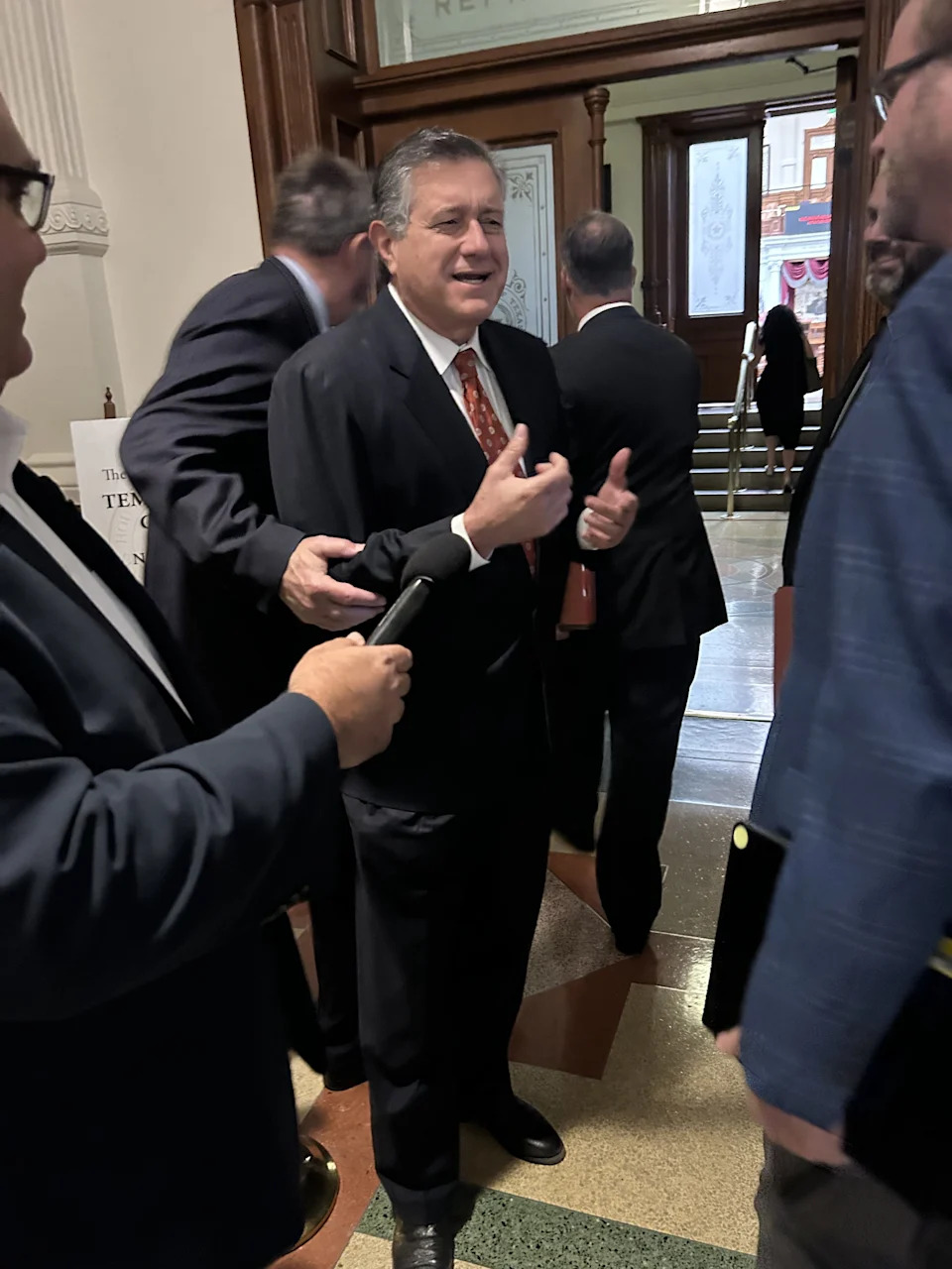 Texas Rep. Richard Peña Raymond, a Democrat from Laredo, talks with other state legislators and the media before a special session on controversial redistricting plans. Raymond stayed behind to oppose the plans, while many of his Democratic colleagues fled to Illinois to break up a required quorum.