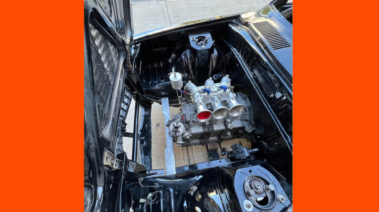 The motor in the RX-3 engine bay