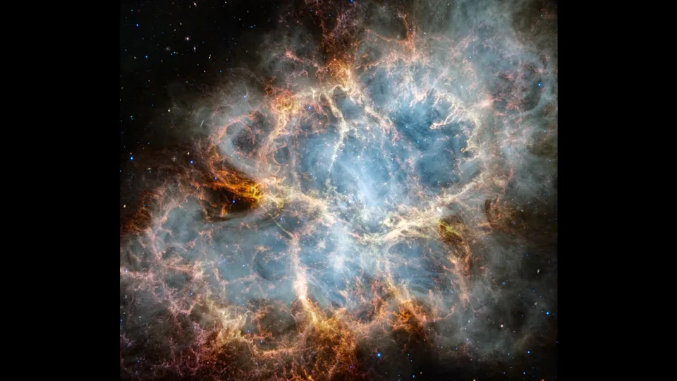 a vast nebula with blue-ish white centers and orange yellow outskirts