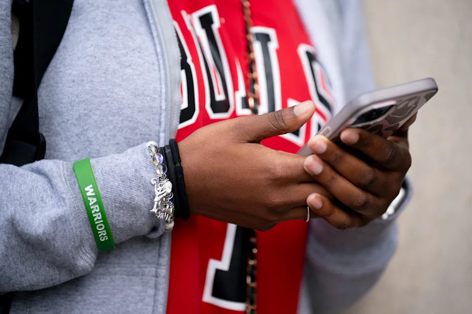 Senior Saniyah Morris, 17, uses her cellphone at KIPP Nashville Collegiate High School in Nashville, Tenn., Wednesday, Feb. 26, 2025. The school uses Yondr pouches for students to lock up their phones during school hours.