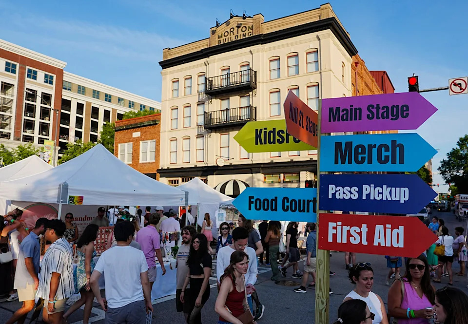 FILE - The sun starts to set at AthFest Music & Arts Festival in downtown Athens on Saturday, June 21, 2025. Athens was recently ranked one of the least dirty cities in the U.S.