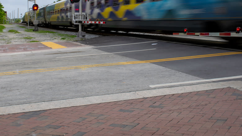 A Brightline train going through a grade crossing