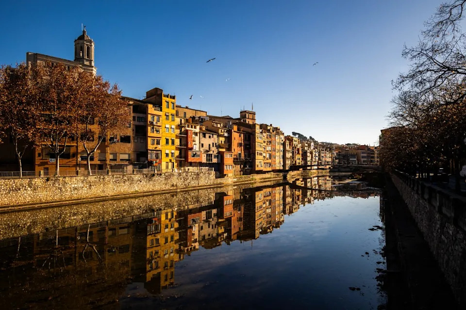 View of Girona’s colorful facades and their reflection and the city’s bridges from the banks of the riu Onyar in Girona in Catalonia in the northern Spain on December 27, 2024. (Photo by Jc Milhet / Hans Lucas / Hans Lucas via AFP) (Photo by JC MILHET/Hans Lucas/AFP via Getty Images)