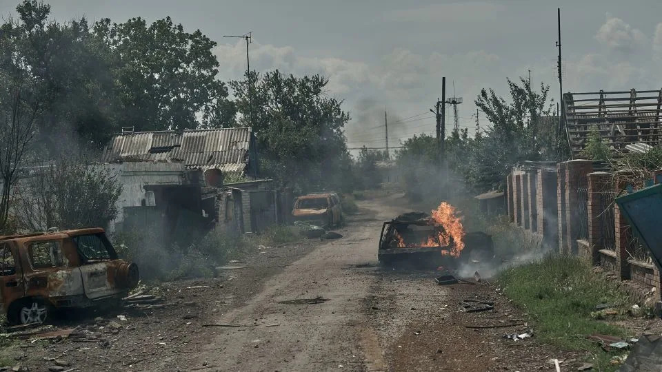 Burnt cars lie in the street as civilians are evacuated from Pokrovsk, Ukraine, by police on June 19. - Kostiantyn Liberov/Libkos/Getty Images