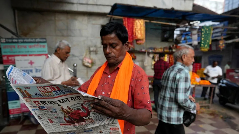A man reads a Hindi-language newspaper in Lucknow, Uttar Pradesh, India, in November 2024. - Rajesh Kumar Singh/AP