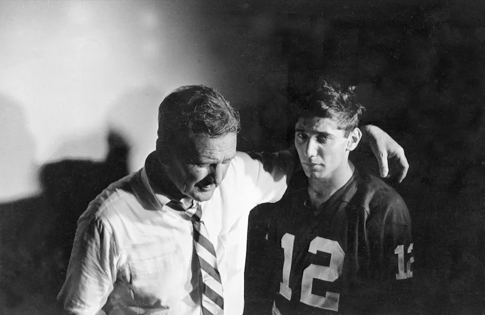 FILE - In this Jan. 1, 1965, file photo, Alabama coach Paul Bryant puts his arm around quarterback Joe Namath in the dressing room after losing to Texas in the Orange Bowl NCAA college football game in Miami. Alabama (10-1), led by Namath, was named No. 1 in both the AP and coaches poll at the end of the regular season. Notre Dame was ranked No. 1 for the last month of the season, but was upset in the season finale by Southern California. (AP Photo/File)