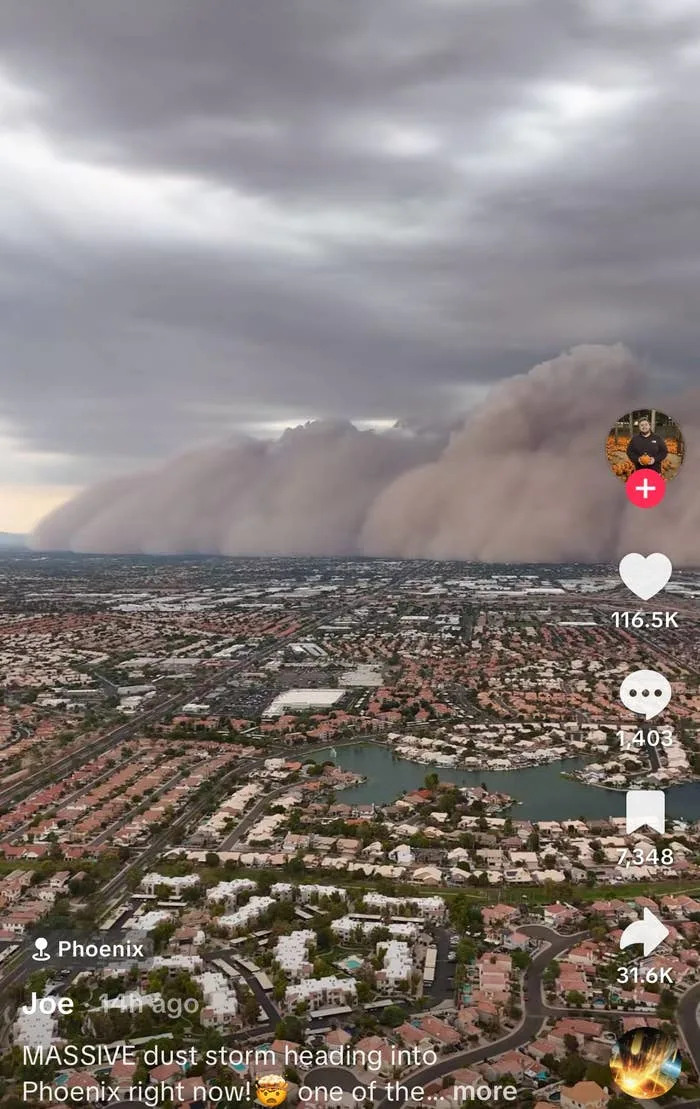 Massive dust storm approaching Phoenix, visible from above. The city's landscape is beneath ominous clouds, with user interactions on display
