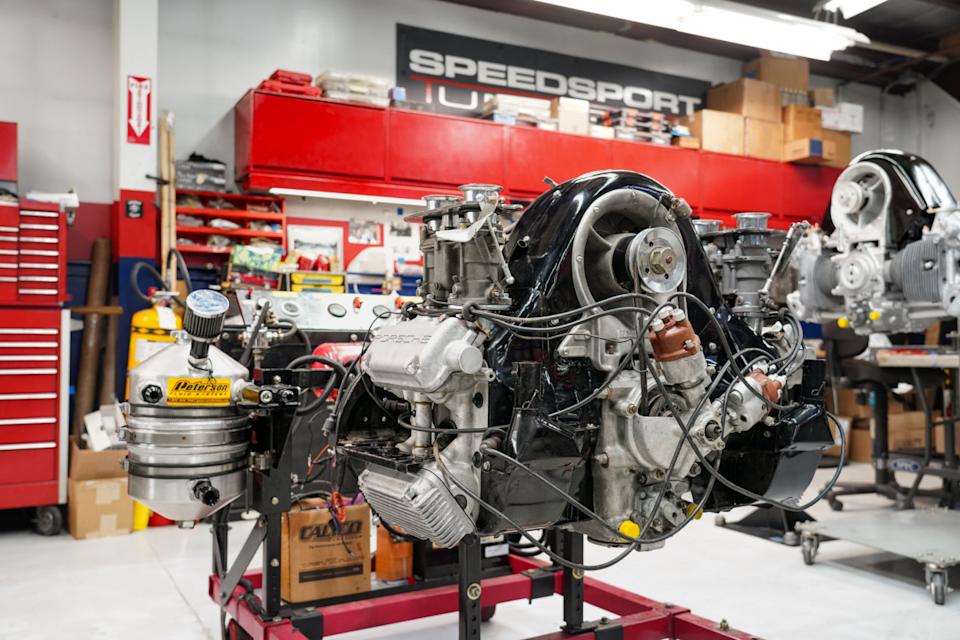 A Porsche four-cam engine, one of a half dozen being overhauled by SST, sits waiting for parts and care. The engines made the company famous in the 1950s during winning exploits at places like Le Mans.