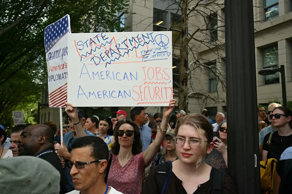 Supporters protest outside the State Department after the agency laid off workers (AFP via Getty Images)