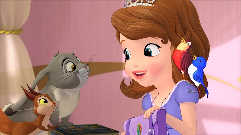 Animated girl with a tiara holding a book smiles at a rabbit, squirrel, and birds on her arm in a cozy setting