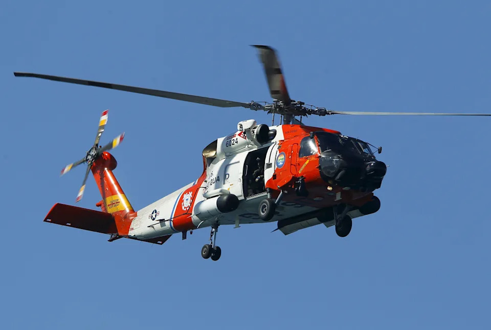 A U.S. Coast Guard helicopter hovers over as first responders take part in a mass-rescue exercise centering around a mock airliner crash-landing in the sea near Ocean Beach, California, September 30, 2015. REUTERS/Mike Blake
