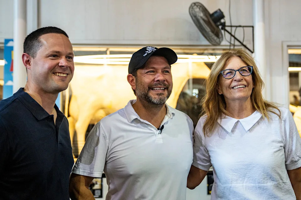 From left: State Sen. Matt Blake, D-Urbandale, U.S. Sen. Ruben Gallego, D-Arizona, and Iowa Democratic Party Chair Rita Hart pose for photos with the butter cow during the second day of the Iowa State Fair on Aug. 8, 2025, in Des Moines, Iowa.