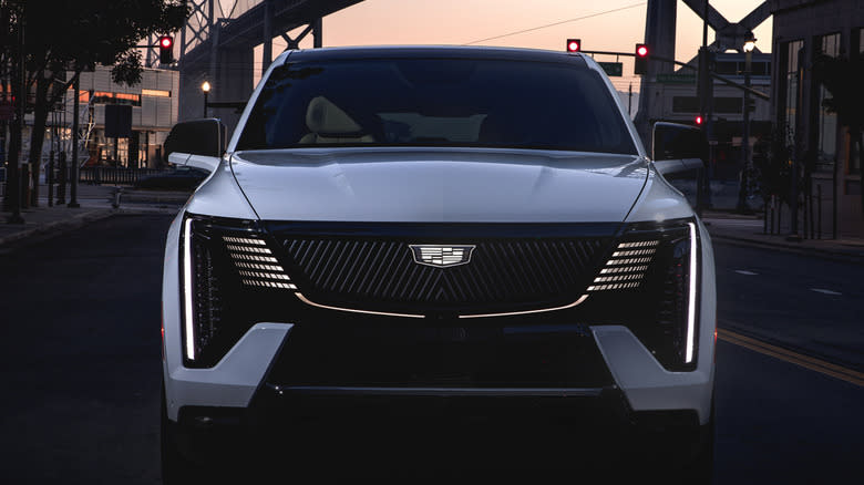 2A 025 Cadillac Escalade IQ in front of a suspension bridge