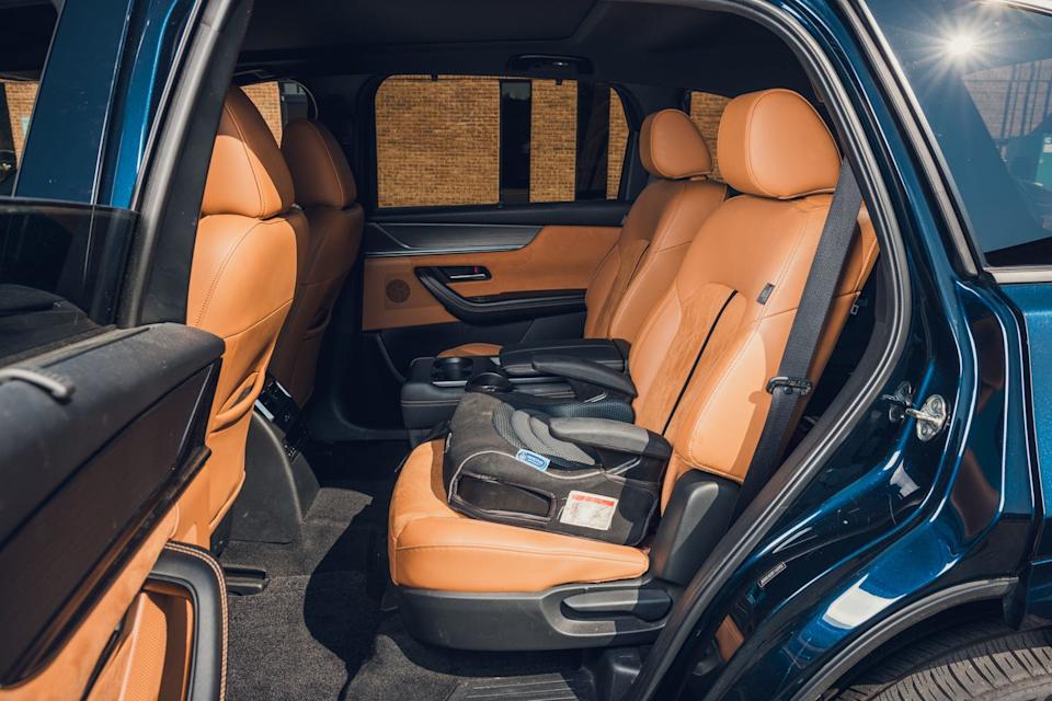 2024 mazda cx 90 with booster seat attached to second row seat behind driver