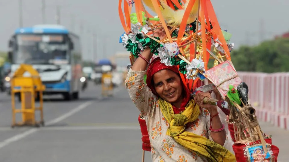 A Lord Shiva devotee carries sacred Ganga Jal (holy water) during the ongoing Kanwar Yatra in New Delhi, India on July 15, 2025. - Naveen Sharma/SOPA Images/LightRocket/Getty Images