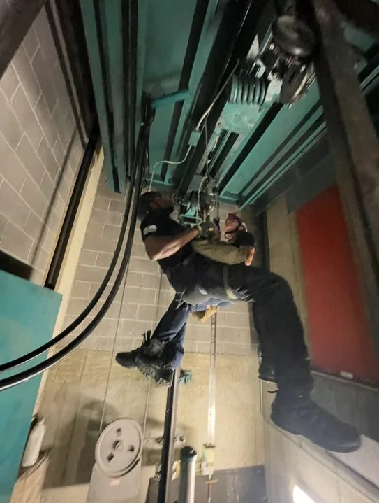 SWAT officer hanging from ropes during training