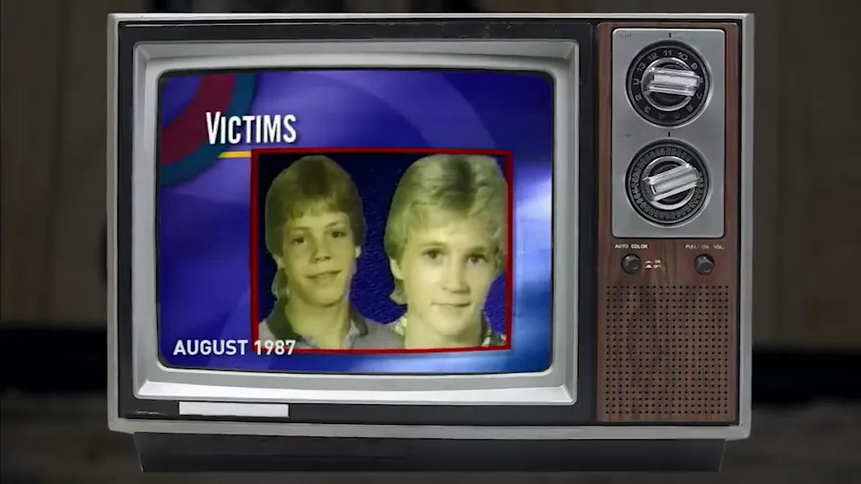 A TV showing a news report about Kevin Ives and Don Henry