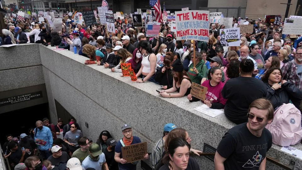 Demonstrators take part in the "No Kings Day" protest on June 14 in Chicago. - Nam Y. Huh/AP