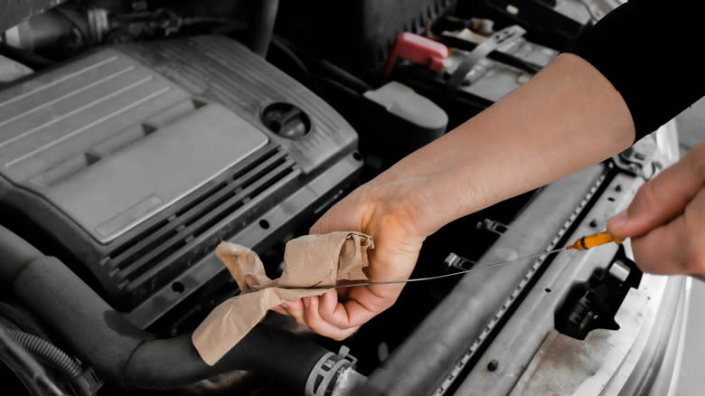 Checking oil with a dipstick
