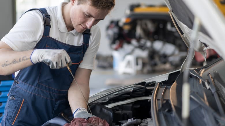 A mechanic performing an oil change