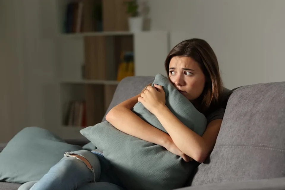 Woman at home feeling anxious.