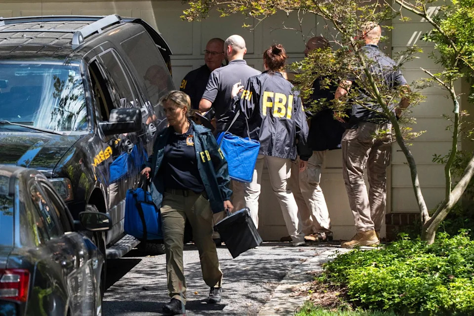 FBI agents leave the house of former national security adviser John Bolton in Bethesda, Maryland as part of the ‘early stages’ of an investigation related to classified documents, Vice President JD Vance has said (AP)