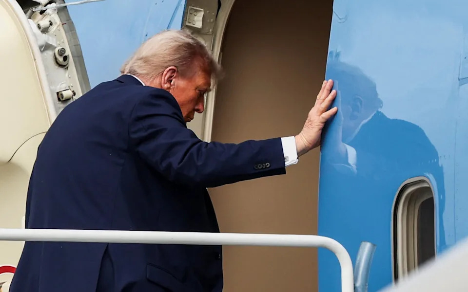 US President Donald Trump boards Air Force One following his meeting with Russian president Vladimir Putin