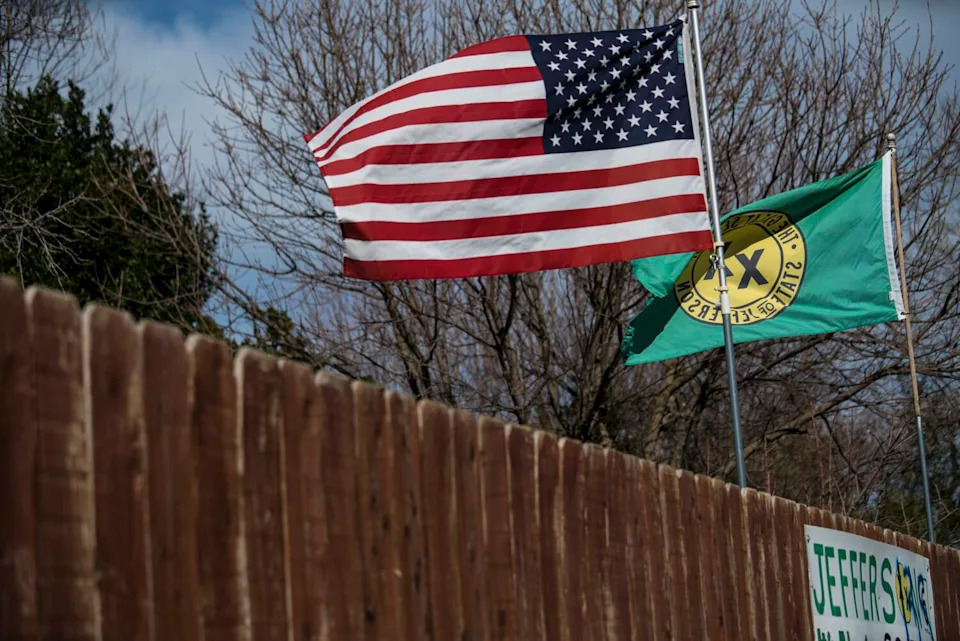 A Feb. 2018 photo shows the flags of the United States and the "State of Jefferson" in Anderson, Calif.