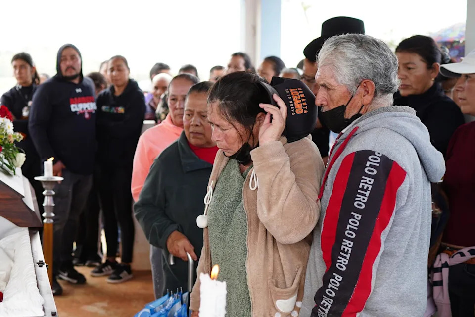 Community members gather for a funeral.