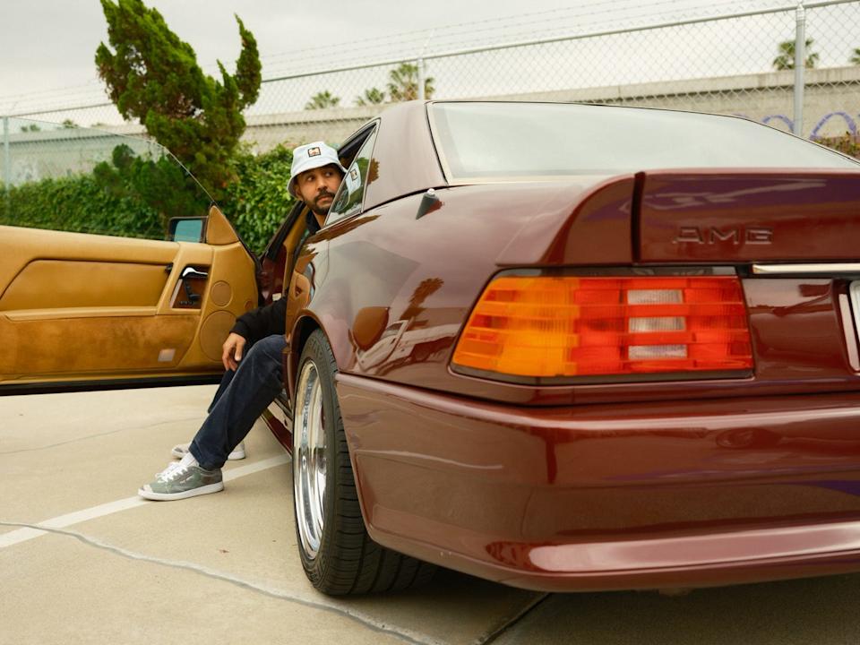 a classic car parked with the drivers door open showcasing its interior