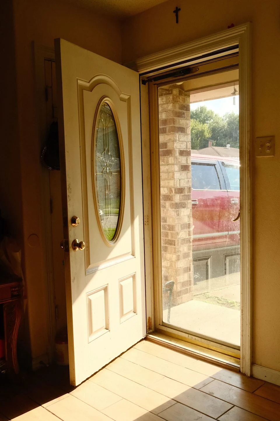 Lakeita Williams was rescued by canoe in the front yard of her mother's home. The cross above the door has remained there since before the storm. (Brandon Holland for NBC News)
