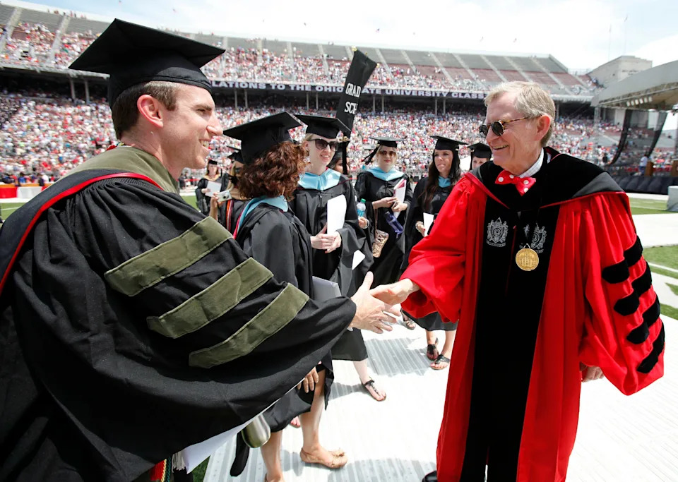 Then-Ohio State President E. Gordon Gee shakes hands with graduates at spring commencement at Ohio Stadium in 2012. The ceremony was the university's 400th commencement and Ohio State's last on the academic quarter system.