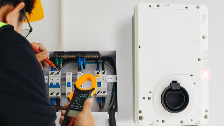 An electrician installs a home EV charger