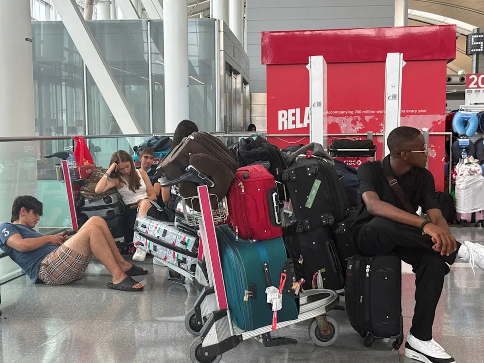People sit with their luggage, as Air Canada flight attendants said they will remain on strike (Reuters)